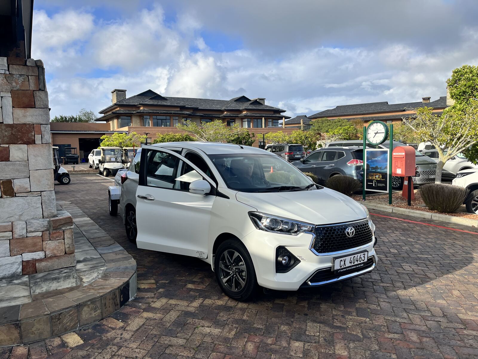 Toyota Rumion arriving with luggage trailer at a golf estate